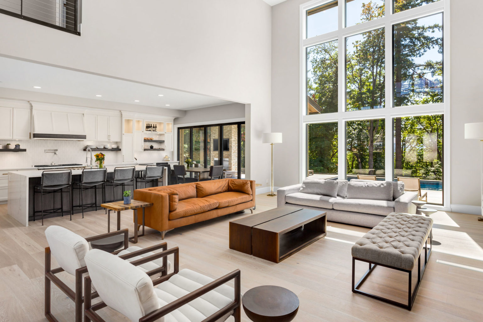 White interior modern furnished home with large multi level windows